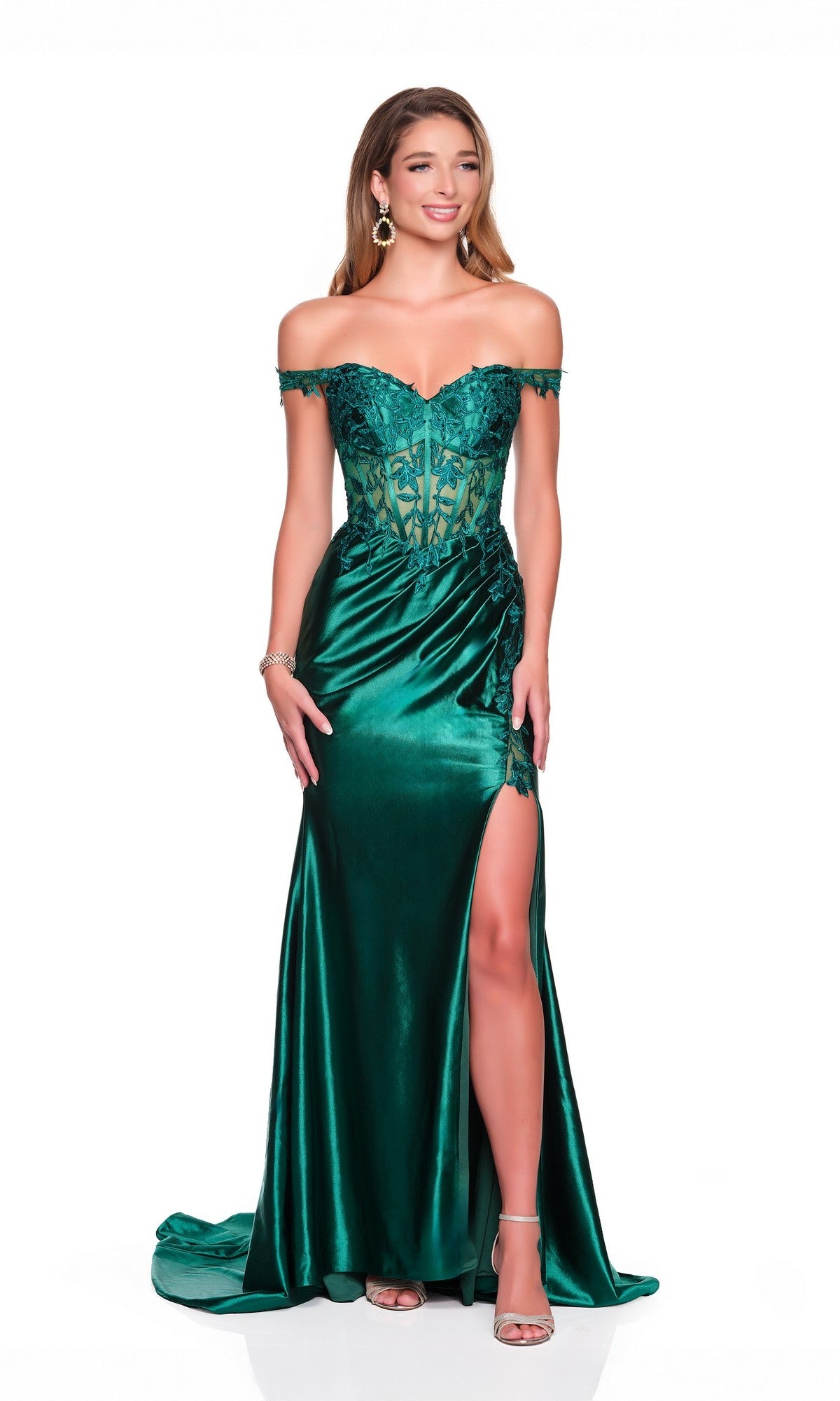 A woman in the Dave and Johnny 12689 long prom dress, featuring emerald satin, off-the-shoulder lace details, and a high slit, stands against a white background.